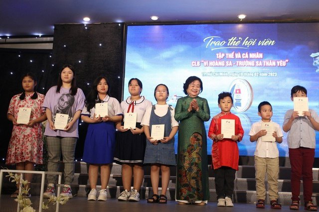 Nguyên Phó Chủ tịch nước Trương Mỹ Hoa, Chủ tịch Quỹ học bổng Vừ A Dính, Chủ nhiệm Câu lạc bộ "Vì Hoàng Sa-Trường Sa thân yêu" trao thẻ hội viên cho các "hội viên nhí" - Ảnh: VGP/MH